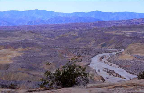 Photo of the meandering Fish Creek Wash and the surrounding treeless badlands, taken from the Wind Caves on the side of the Fish Creek Mountains