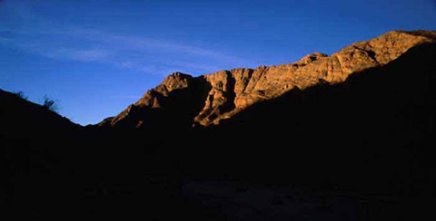 Photo of the morning sun touching the top of Split Mountain