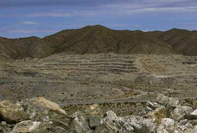 Photo of west wall of the quarry showing stair-steps on the hills left from quarrying from up to 50 years ago